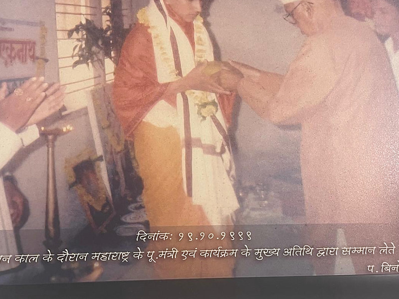 Photograph of a framed historical image showing Acharya Pt. Binod Shastri in ceremonial dress.