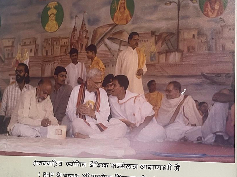 Photograph of a framed historical group image with a printed caption below it.
