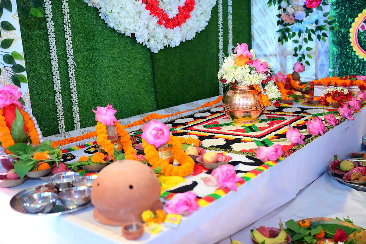 A close view of vessels, offerings and ritual materials arranged on a decorated platform.
