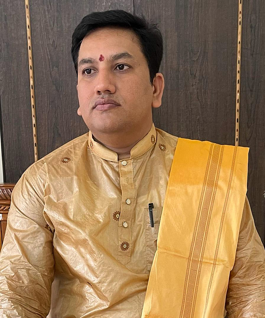 Portrait of Acharya Pt. Binod Shastri in traditional attire.