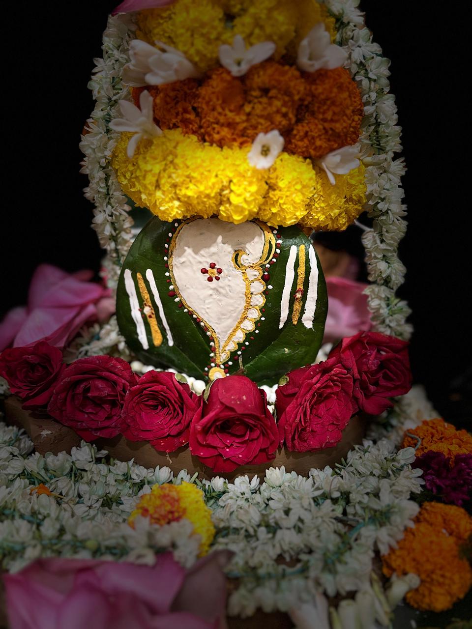 Flower-adorned sacred form prepared for a Shiva observance.