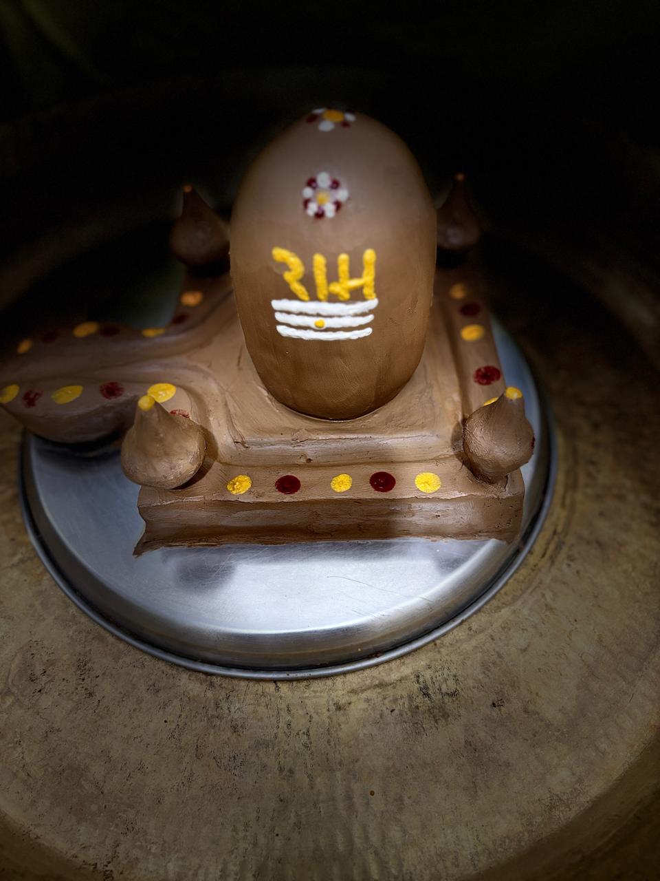 Hand-prepared Shiva lingam bearing sacred markings.