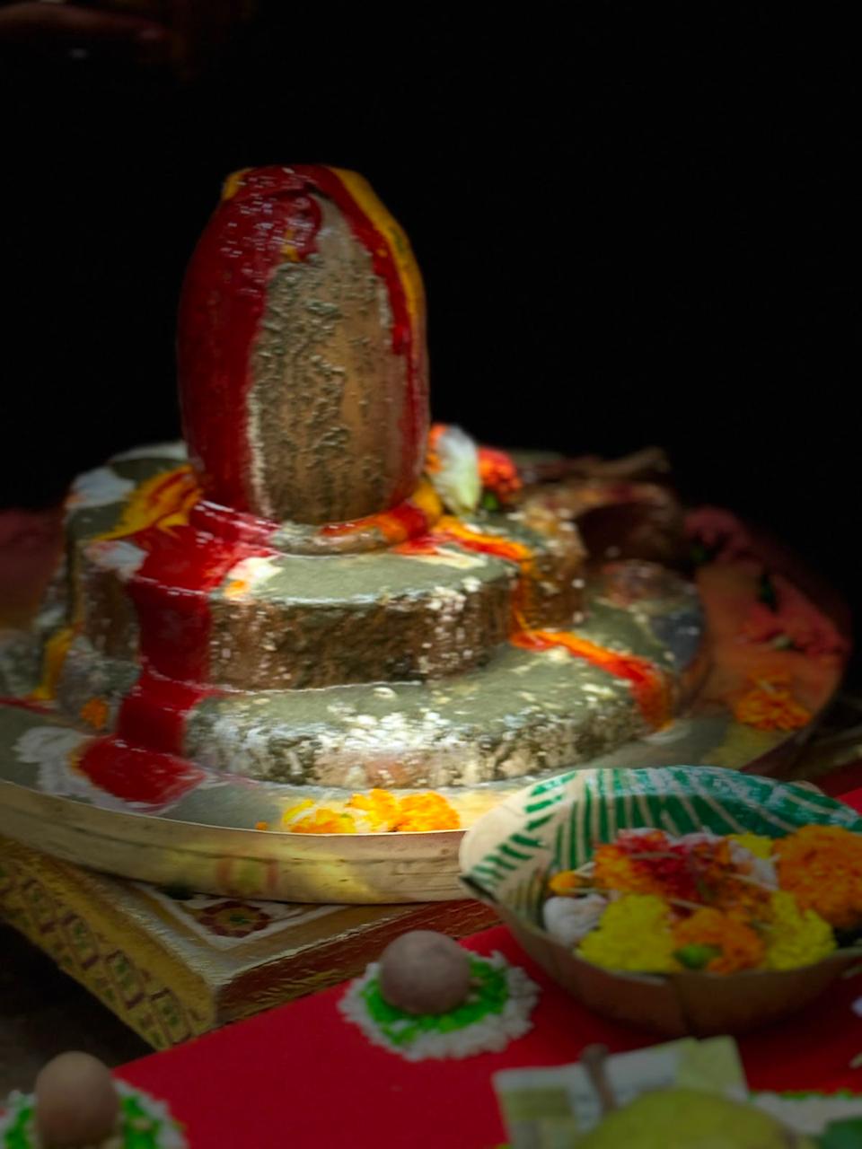Shiva lingam and offerings arranged for worship.
