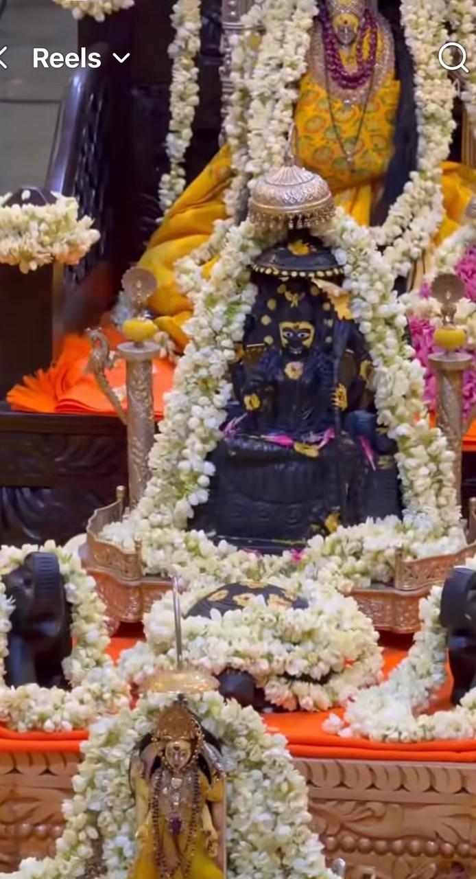 Flower-adorned temple shrine during worship.